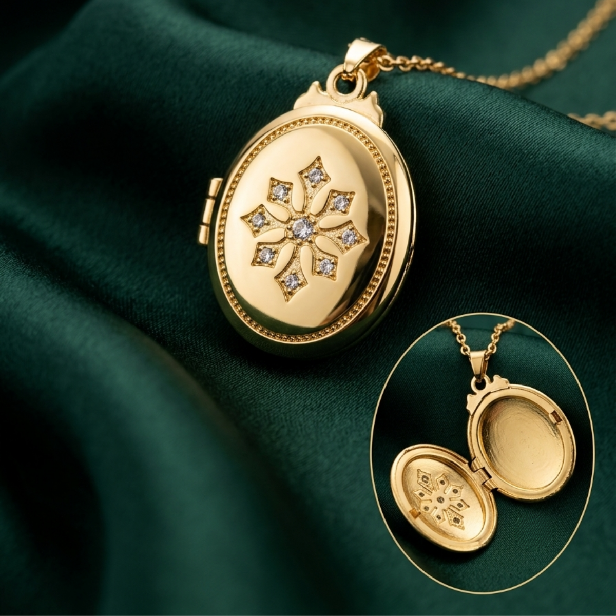 Gold oval locket necklace with a floral star design set with small clear stones, shown on dark green satin fabric with an inset view of the locket open to show the inside.