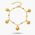 18kt gold plated bracelet with shell charms floated on a white background.