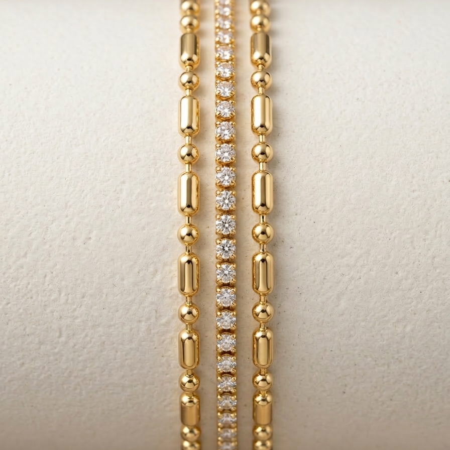 Close up of a wrist wearing a layered 18k gold plated bracelet featuring delicate gold beads and a row of sparkling CZ diamonds.