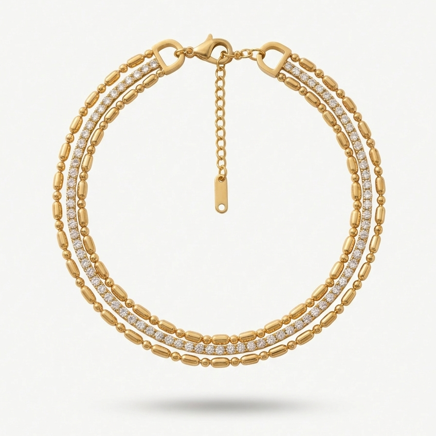 wrist wearing a layered 18k gold plated bracelet featuring delicate gold beads and a row of sparkling CZ diamonds.