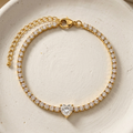 18k gold plated tennis bracelet featuring a row of CZ diamonds and a prominent heart-shaped center diamond.
