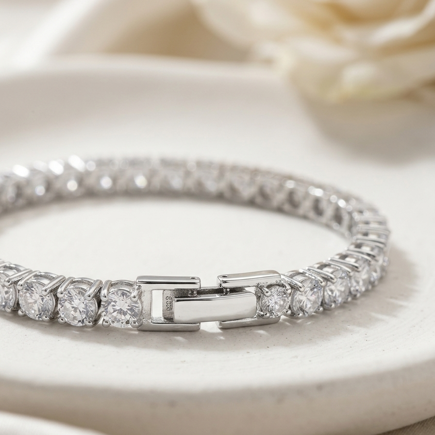 premium silver-tone rhodium plated tennis bracelet featuring a continuous row of sparkling CZ diamonds and a secure box clasp.