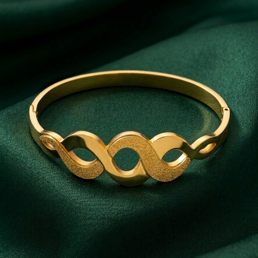 18k gold plated bangle bracelet featuring an infinity wave cutout design with alternating polished and frosted gold textures.