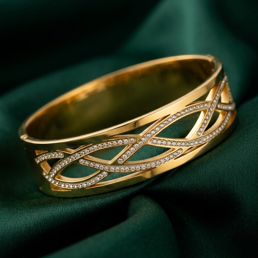 Wide 18k gold plated statement bangle bracelet featuring a criss-cross cutout pattern lined with sparkling pave CZ diamonds on a green fabric background
