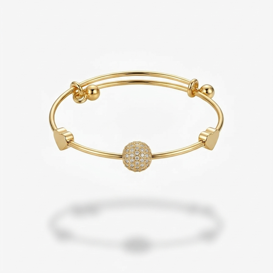 18k gold plated adjustable sliding bangle bracelet featuring a central sphere covered in pave CZ diamonds and two small gold heart accents.