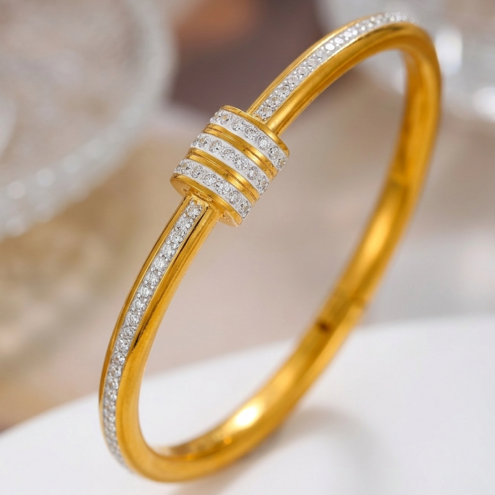 18kt gold plated bangle bracelet with triple row crystal center station on soft white surface.