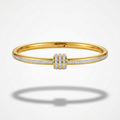 18kt gold plated roller bangle with diamond accents floating on a white background.