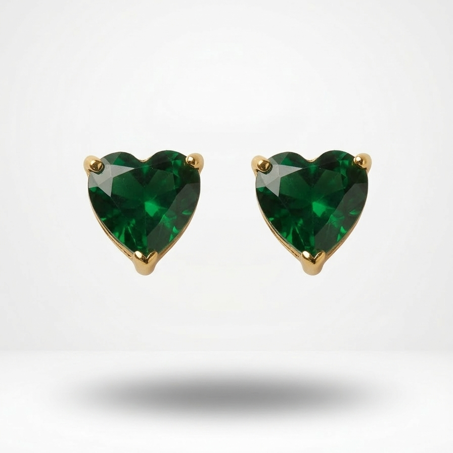Heart-shaped green gemstone earrings with gold settings on a white background