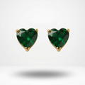 Heart-shaped green gemstone earrings with gold settings on a white background