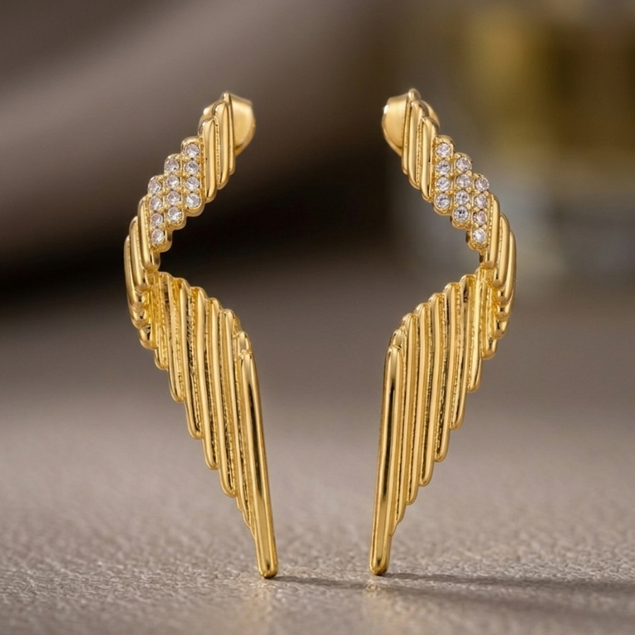 Pair of large 18k gold plated statement drop earrings with a ribbed wing texture and CZ diamond accents at the top.
