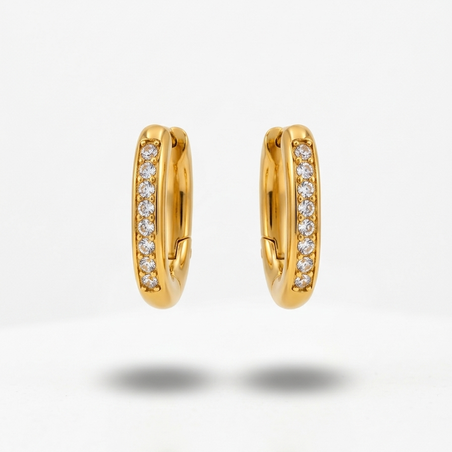 Pair of 18k gold plated oval huggie hoop earrings featuring a center row of sparkling CZ diamonds.