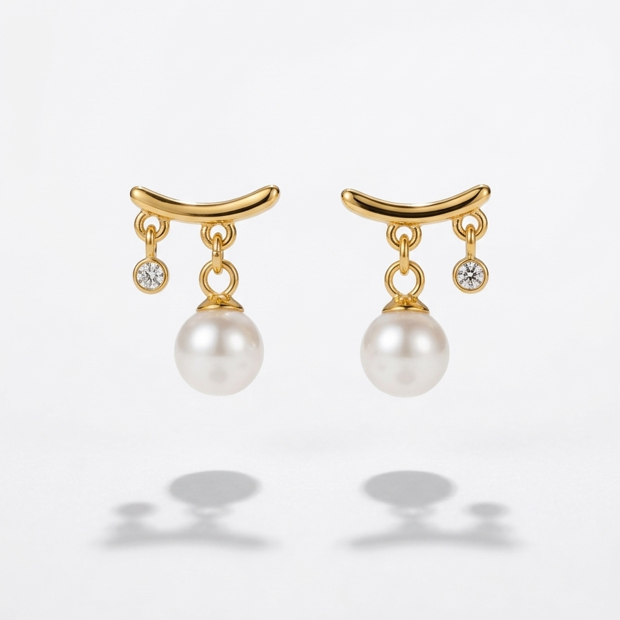 18k gold plated stud earrings featuring a curved gold bar with a dangling white pearl and a smaller dangling CZ diamond.