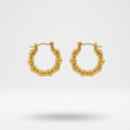 Pair of 18k gold plated mini hoop Huggies earrings featuring a sculpted, textured bamboo design.