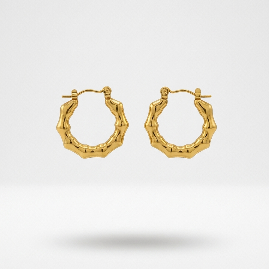 Pair of 18k gold plated mini hoop Huggies earrings featuring a sculpted, textured bamboo design.