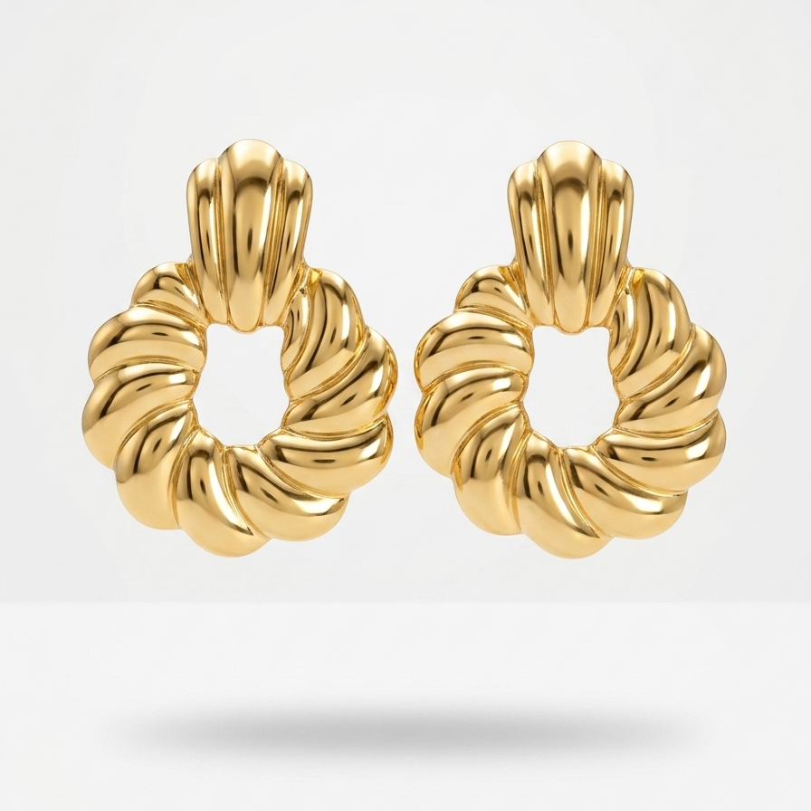 A pair of gold-toned twisted rope hoop earrings with a polished finish, displayed on a clean light gray background.