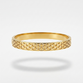 A gold bangle bracelet with an openwork geometric lattice pattern, shown against a light gray background with a soft shadow underneath.