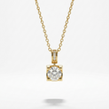 A yellow gold necklace with a delicate chain and a square pendant featuring a round clear gemstone surrounded by small side stones, shown on a light gray background.