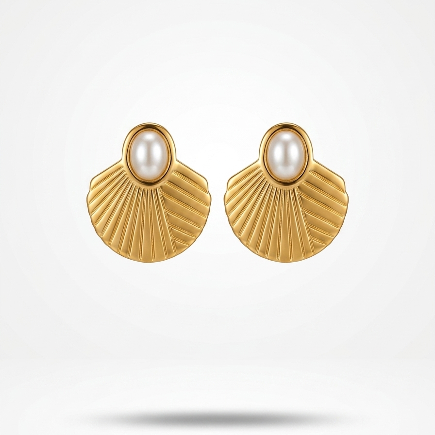 A pair of gold shell-shaped stud earrings with a white pearl at the center, displayed on a clean white background with a soft shadow underneath.