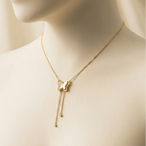 Gold butterfly necklace with dangling tassels and white inlay on packaging card.