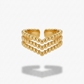 A gold-toned triple-row beaded ring with a scalloped inner edge, shown on a light gray background with a soft shadow underneath.