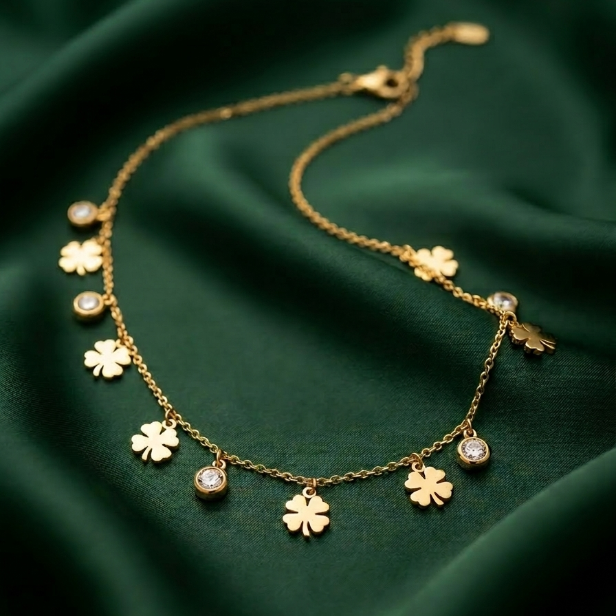 18k gold plated station necklace featuring evenly spaced minimalist daisy charms and bezel-set clear CZ crystals on a green fabric background