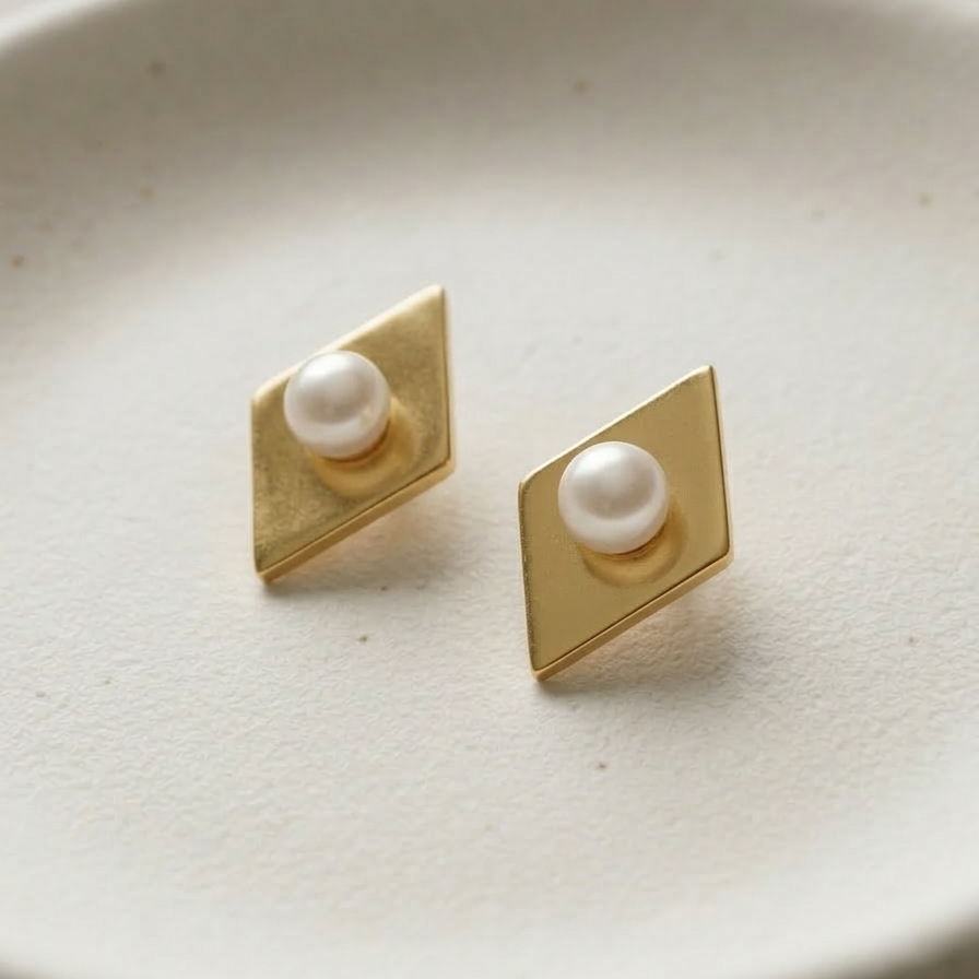 18k gold plated diamond-shaped stud earrings with a brushed matte finish and a single pearl set in the center.