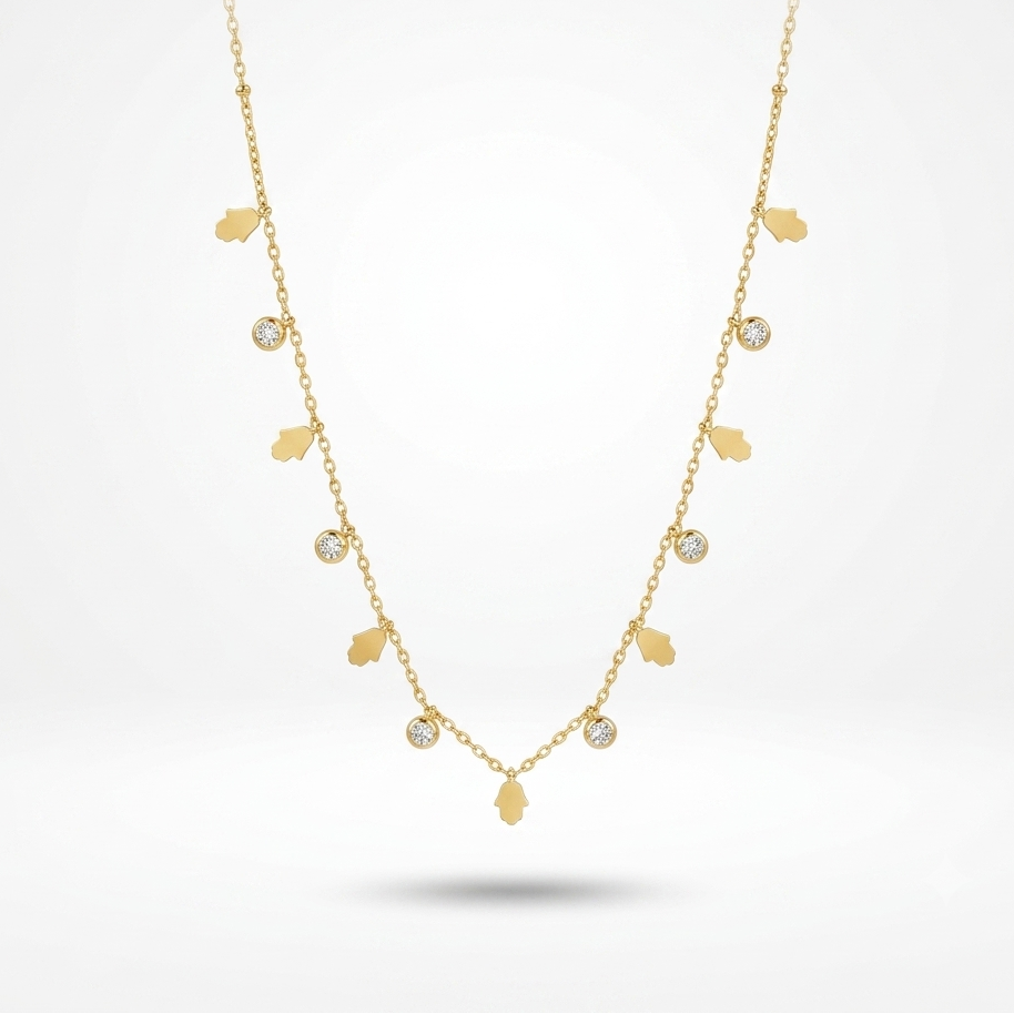 A delicate gold necklace featuring small gold leaf charms and several round clear gemstone accents, displayed against a clean white background.