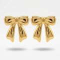 18kt gold plated bow-shaped studs floating on a light gray background.
