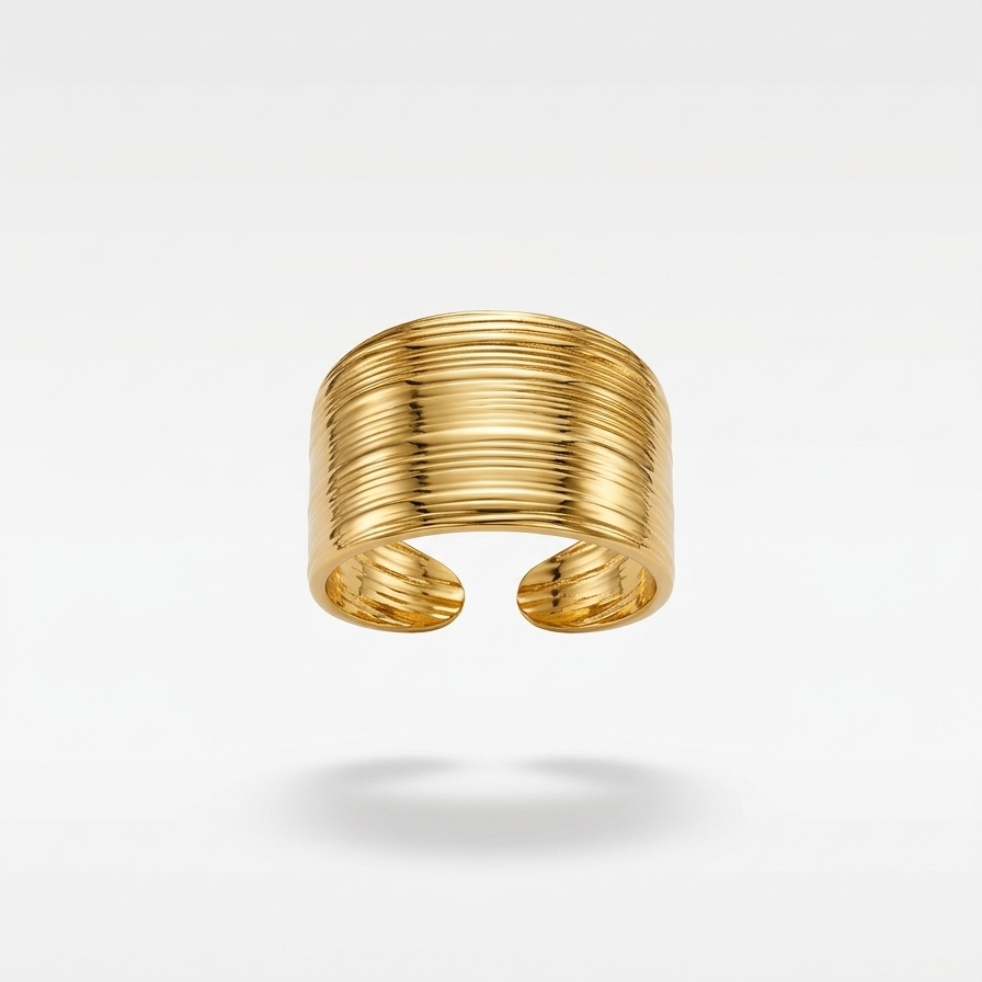 18kt gold plaed ring with a ribbed texture floating on a white background