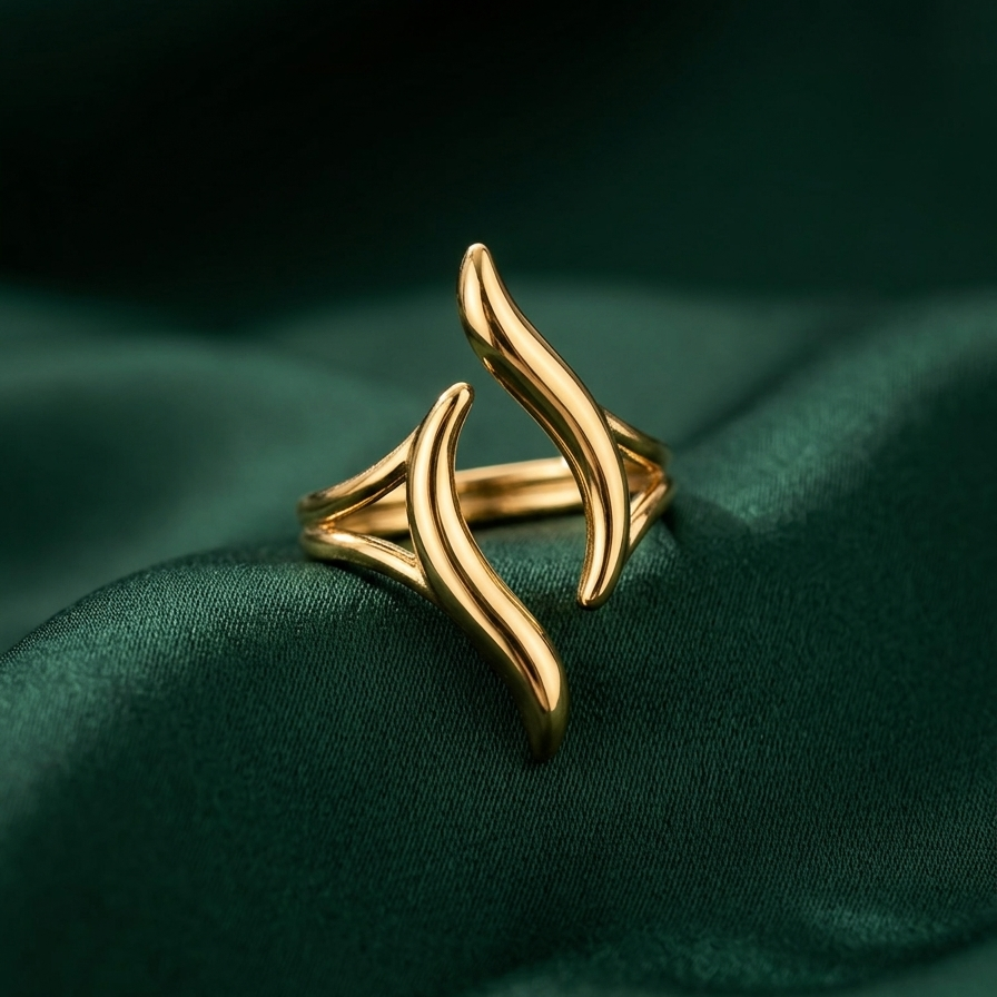 18kt gold plated ring with a unique wavy design on a green fabric background