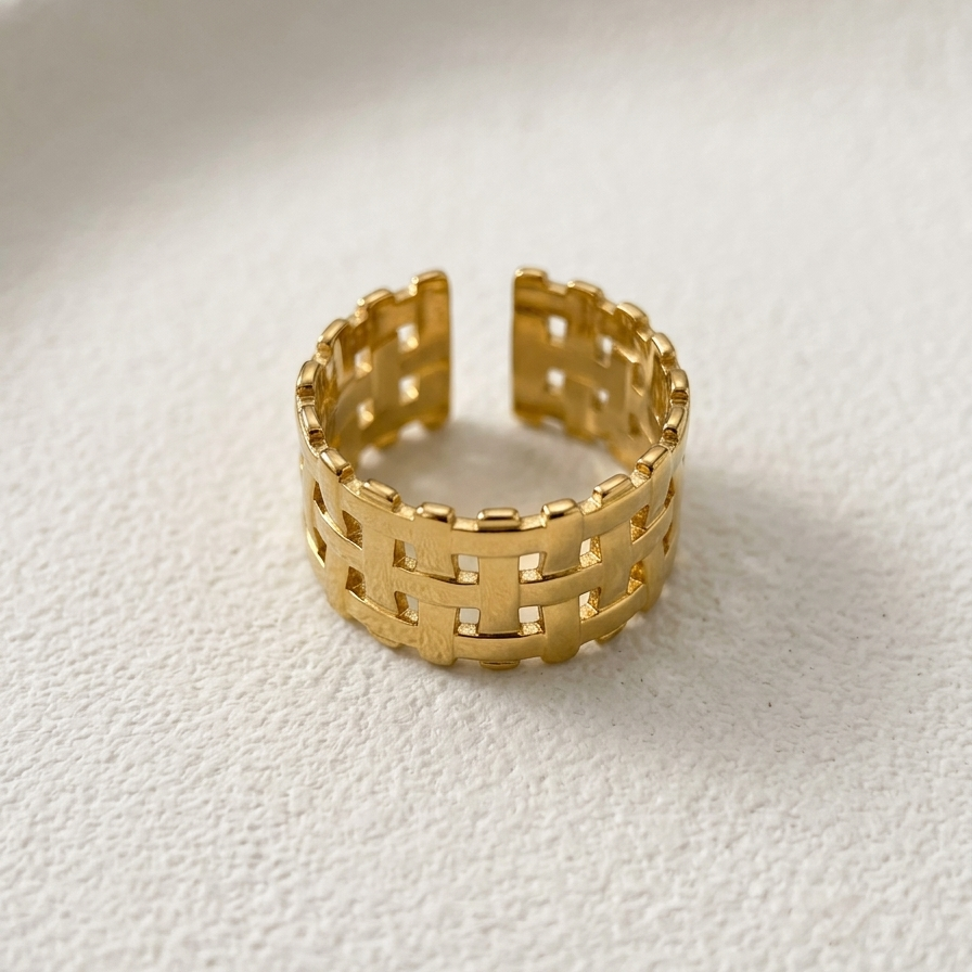 18kt gold plated ring with a woven mesh design on a white surface