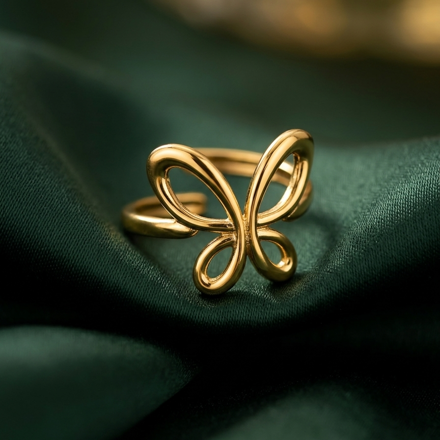 18kt gold plated butterfly ring on a green fabric background