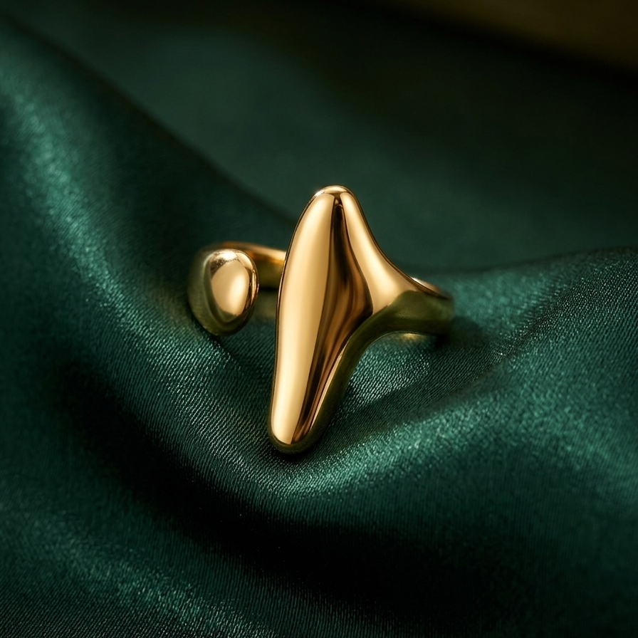 18kt gold plated unique design ring on a green fabric background