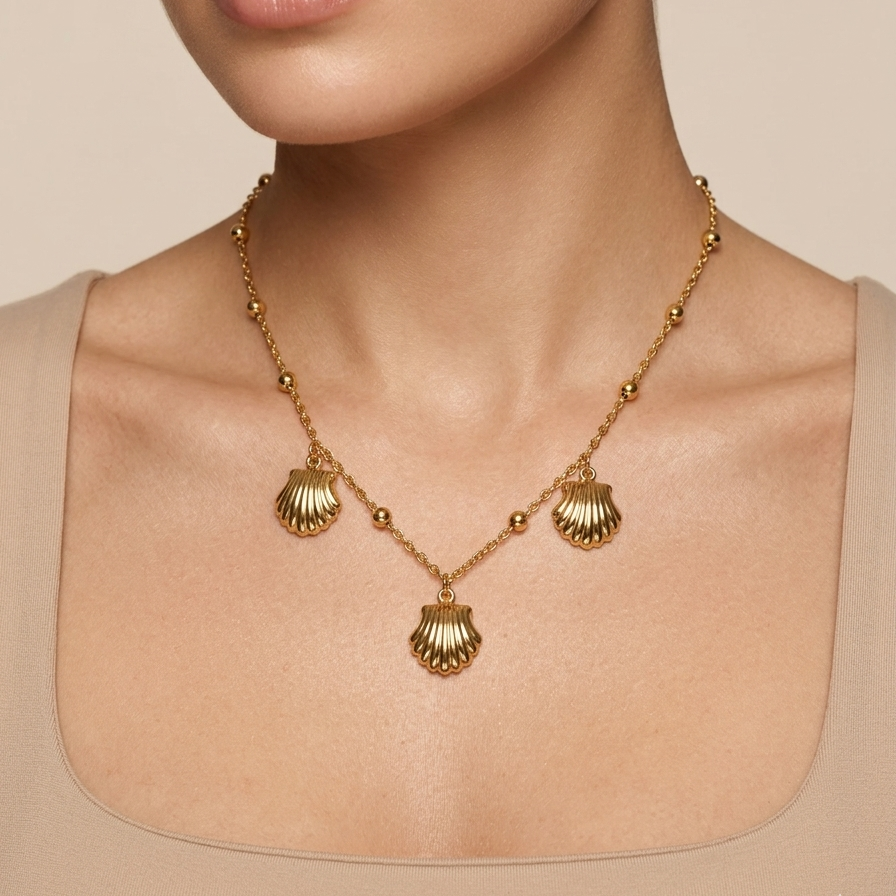18kt gold plated shell charms necklace with beads chain worn by a model on a beige background.