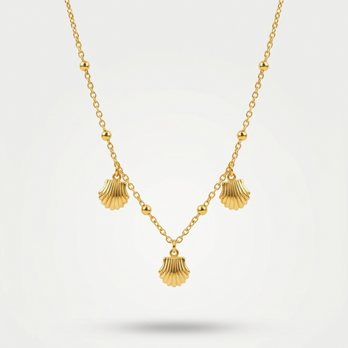 18kt gold plated shell charm necklace with three scallop shells floating on a white background.