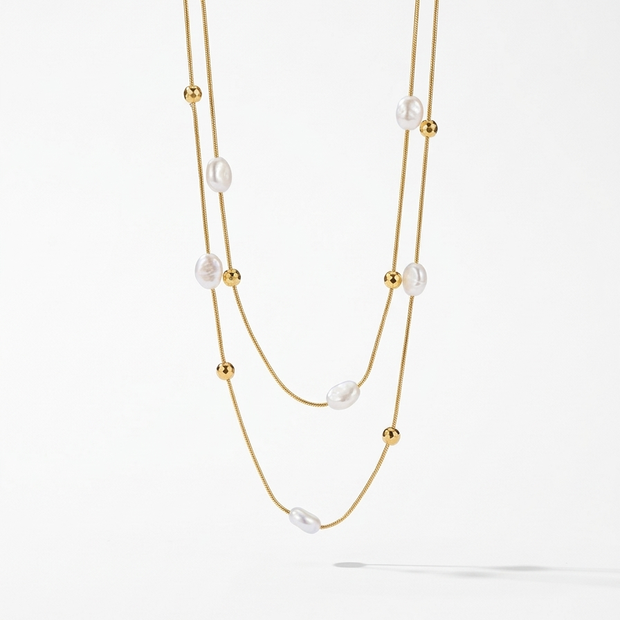18kt gold plated double layered necklace with pearls and beads floated on a white background.