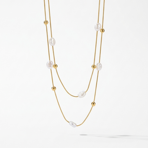 18kt gold plated double layered necklace with pearls and beads floated on a white background.
