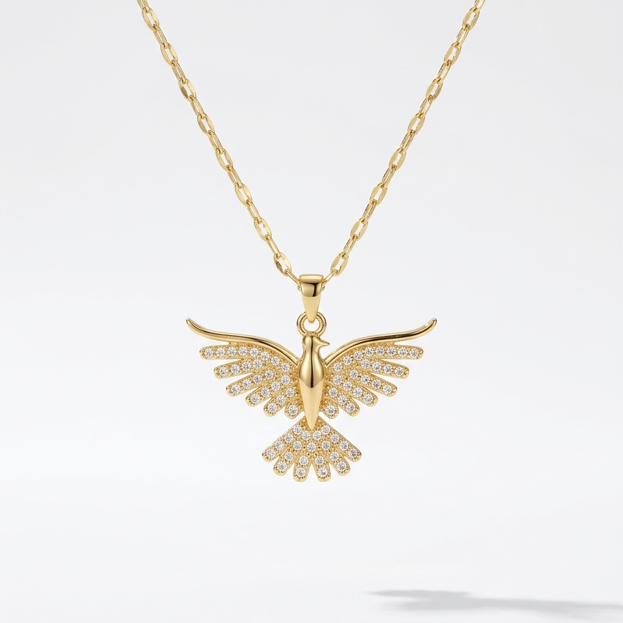 18kt gold plated crystal bird pendant necklace floating on a light gray background.