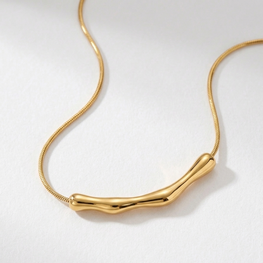 Close-up of 18kt gold plated necklace on a white background.