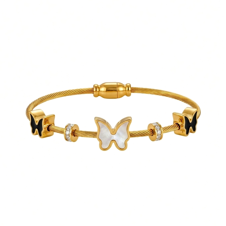 18kt gold plated, waterproof cable wire magnetic bangle bracelet with black and white butterfly charms floating on white background.
