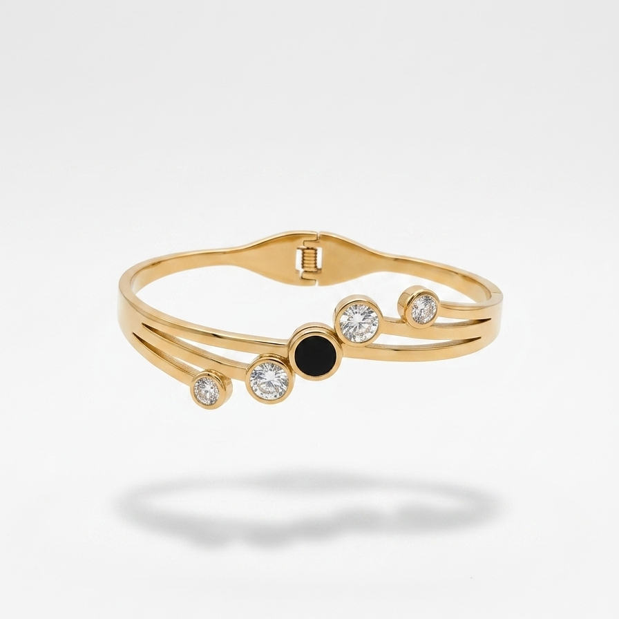 18kt gold plated, waterproof, the onyx crystal orbit bangle bracelet floating on white background.