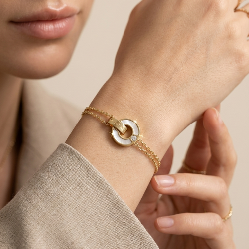 A Indian young woman model worn 18kt gold plated, tarnish free "BELOVED" mother of pearl bracelet on her wrist.