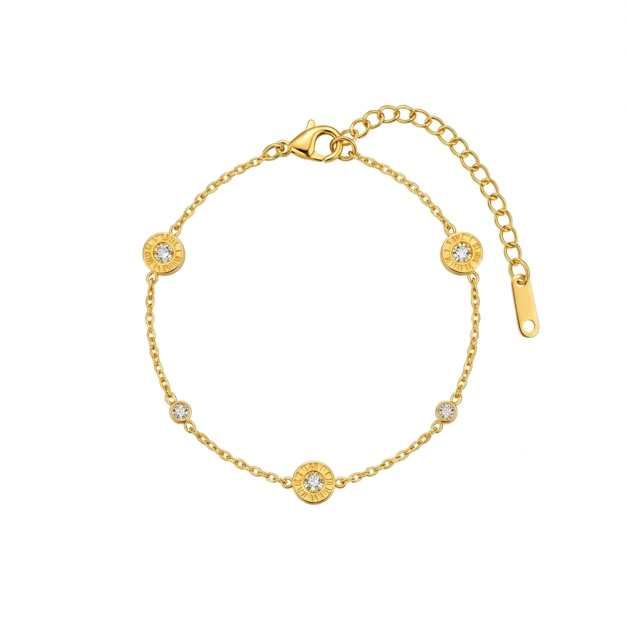 18kt gold plated, anti-tarnish chain bracelet with Roman numeral and crystal station charms floating on white background.