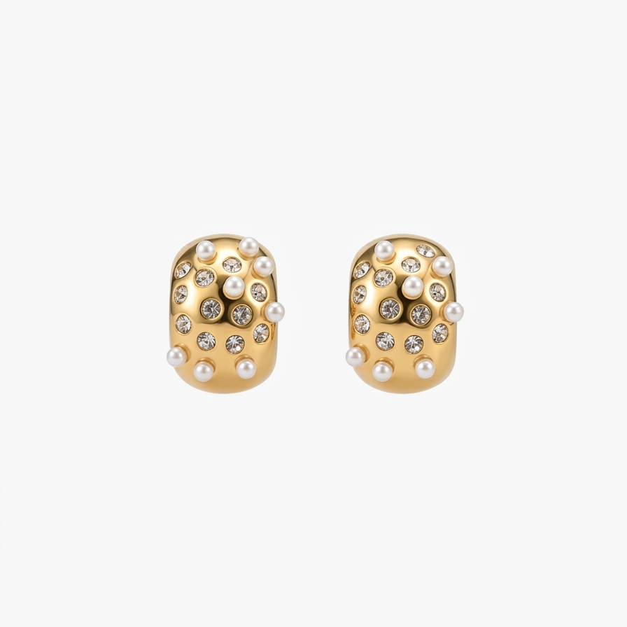 18kt gold plated, anti-tarnish huggie earrings with embedded white pearls and crystals floating on white background.