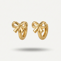 18kt gold plated ribbon bow huggies floating on a white background.