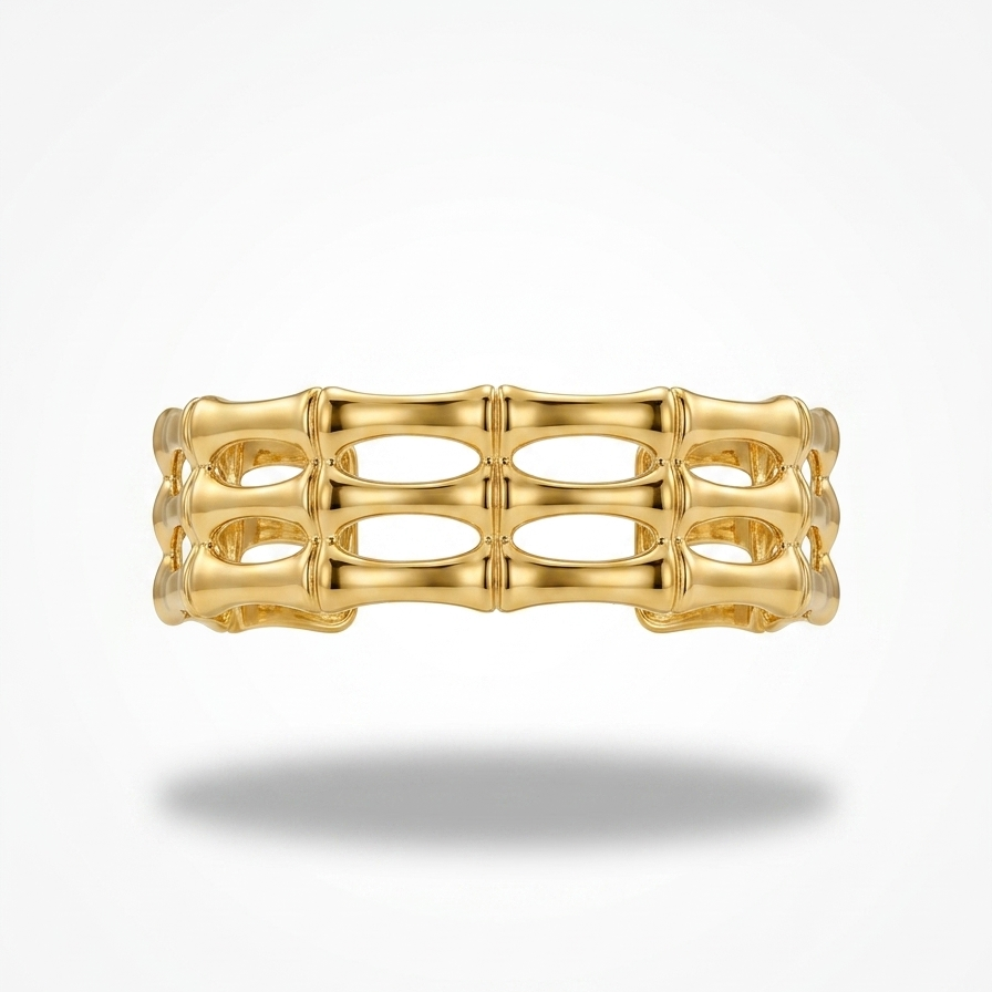 18kt wide gold plated, waterproof cuff bracelet with openwork bamboo design floating on white background.