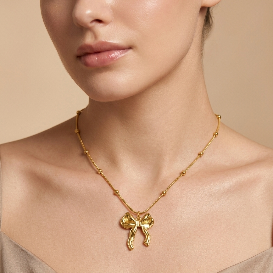 18kt gold plated 3D puffed bow necklace wearing a model.