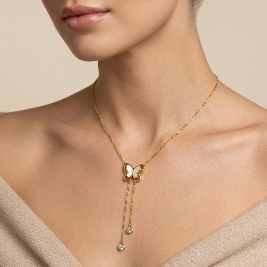 A model wearing 18kt gold plated butterfly necklace with dangling tassels with off-white background.