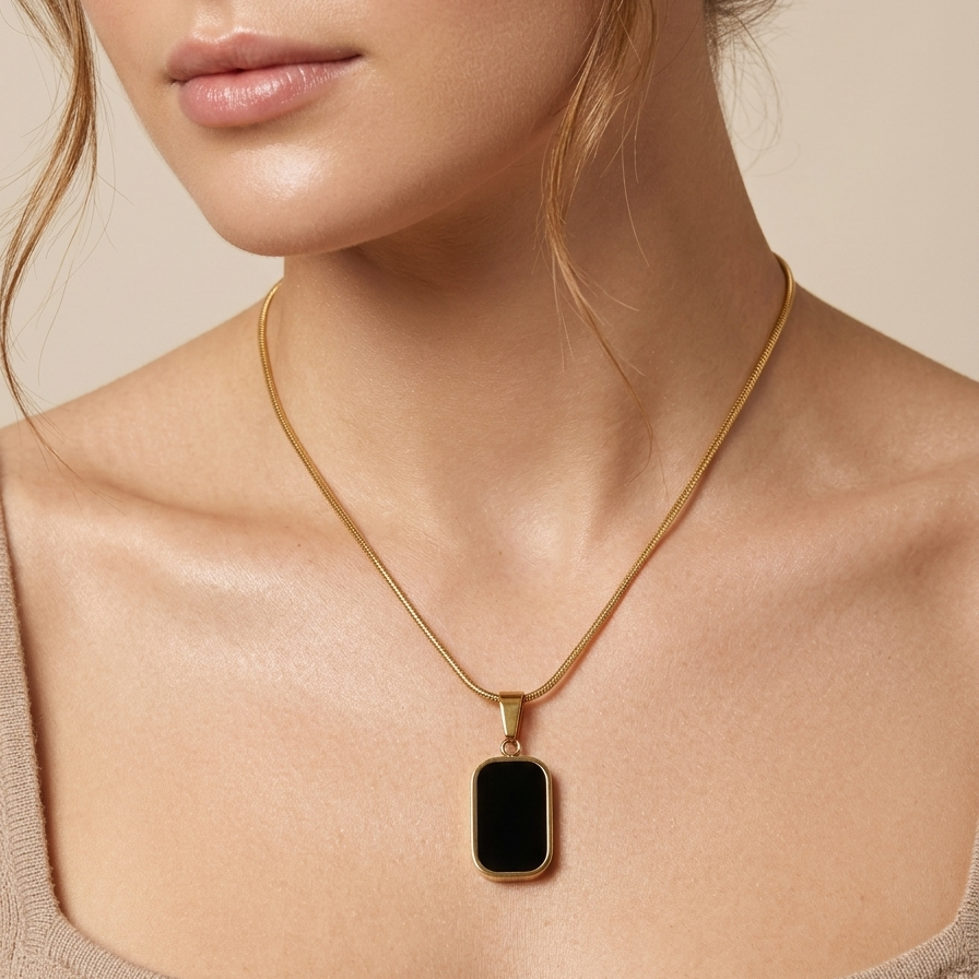 18kt gold plated reversible day and night pendant necklace showing black side on model neck.