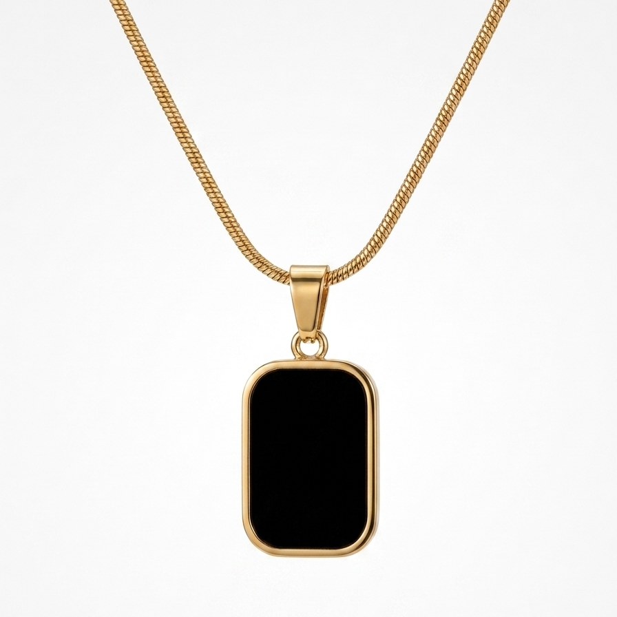 18kt gold plated reversible day and night pendant necklace showing black side floating on white background.